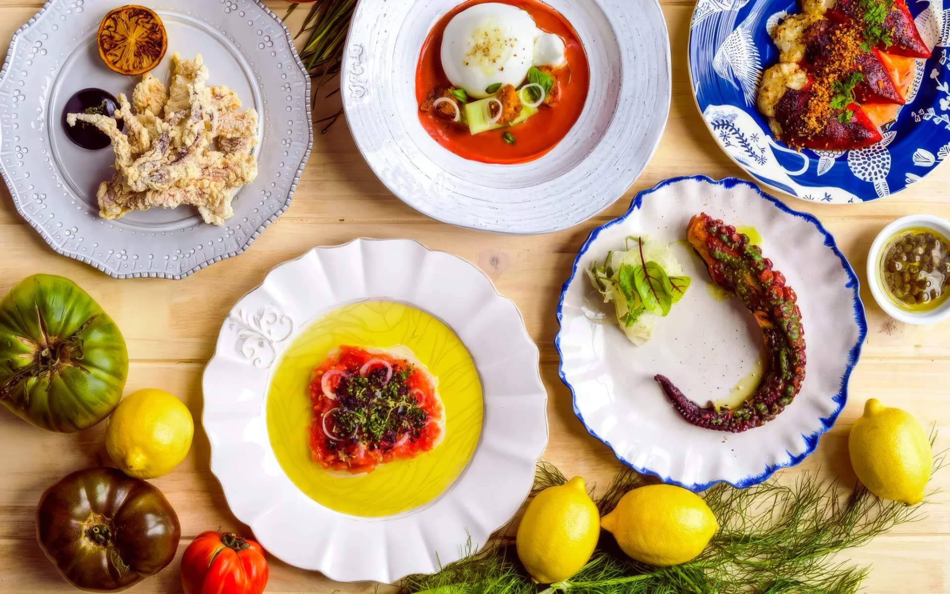 Grilled octopus, crudo, and Spanish plates on the table at Barceloneta