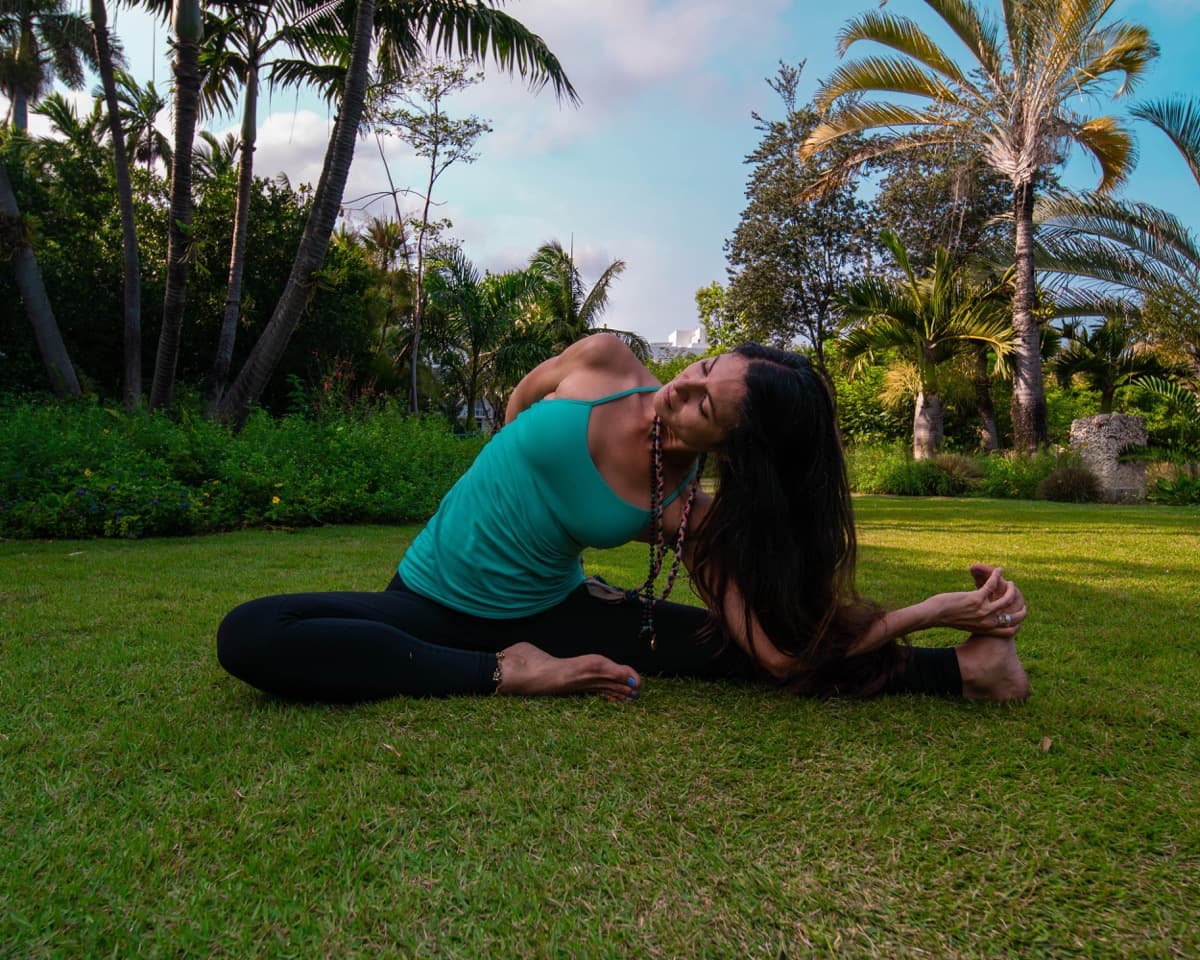 Woman practicing gentle vinyasa yoga in the Miami Beach Botanical Garden