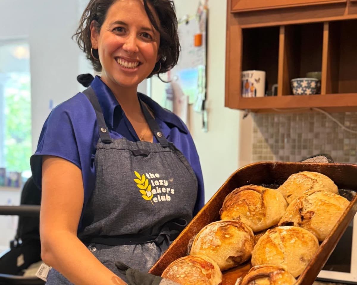 Laura Rodriguez-Costacamps holding freshly baked sourdough loaves